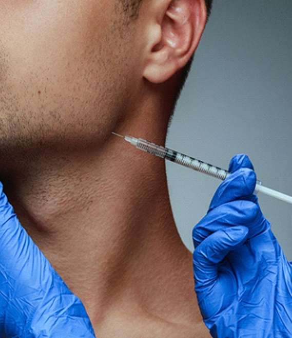 a person receiving a BOTOX injection in their jawline