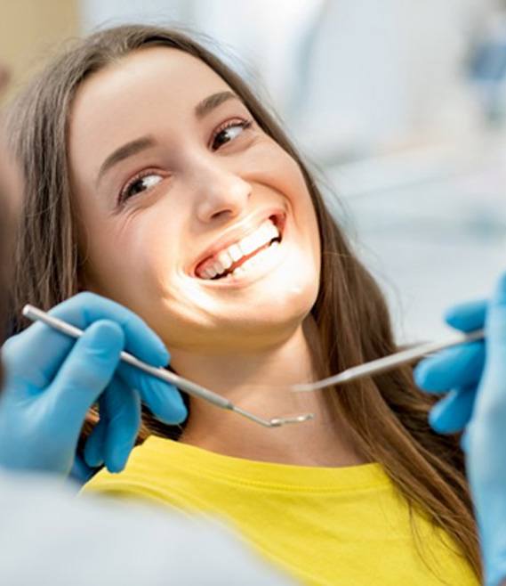 a patient smiling after her dental cleaning