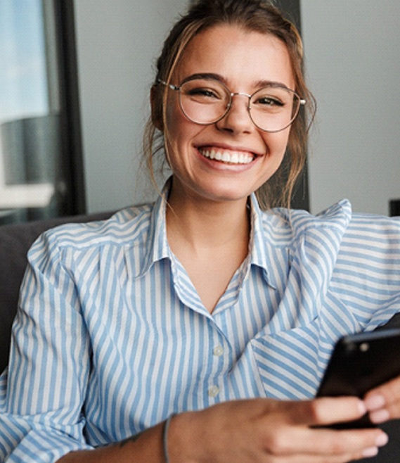 woman with glasses smiling