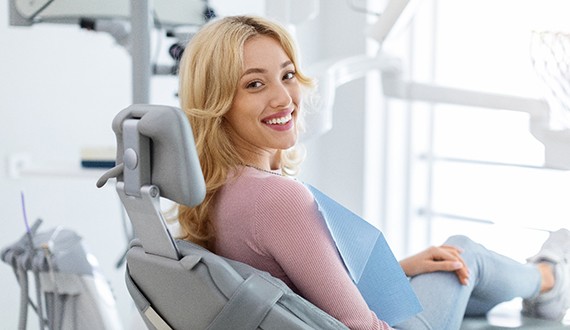 Patient smiling while sitting in treatment chair
