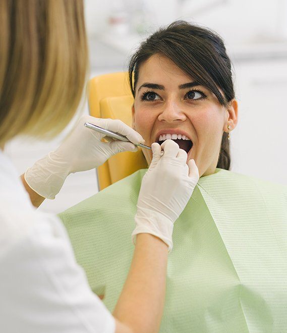 Patient receiving exam to prevent dental emergencies