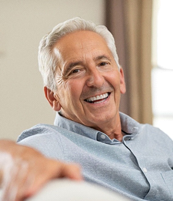 Confident senior man enjoying benefits of implant dentures
