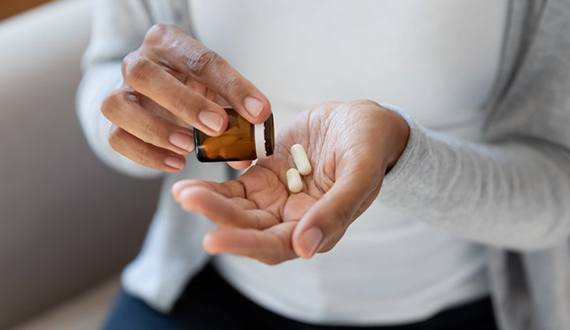 a person preparing to take pain medication