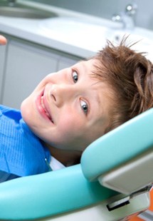 young child smiling in dental chair 