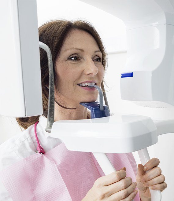 Woman receiving x-ray scan during preventive dentistry checkup visit