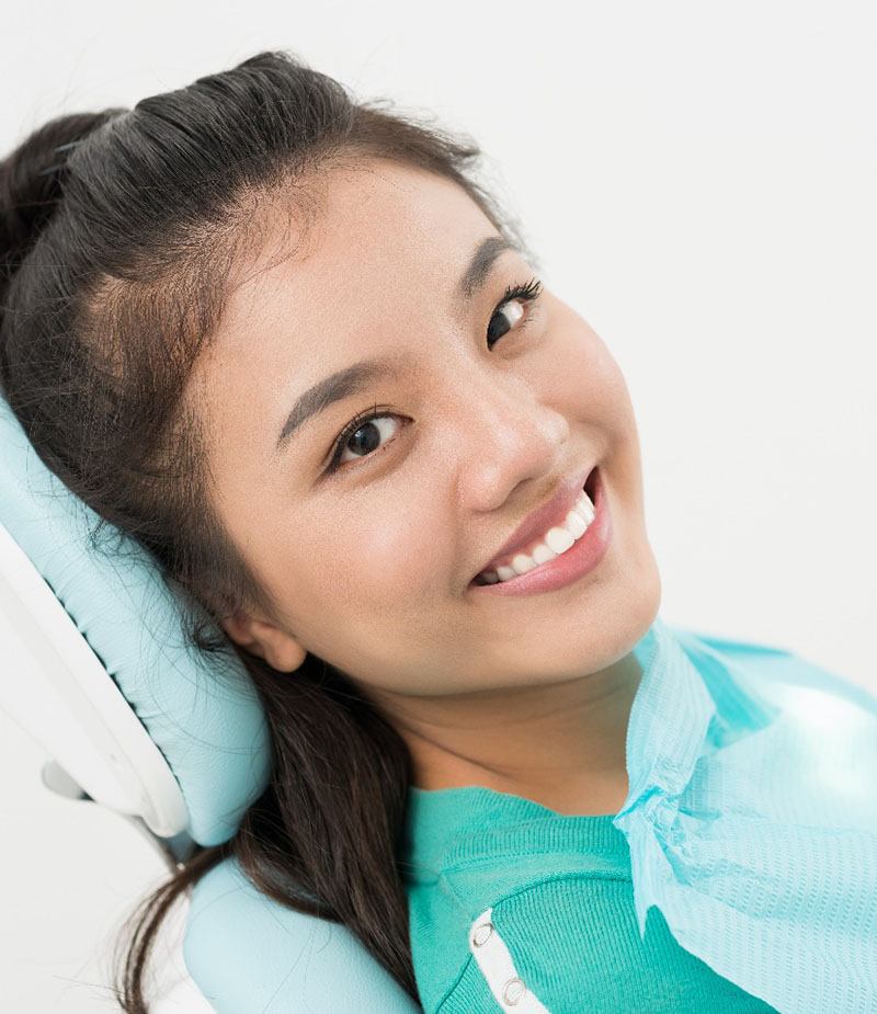 Young woman smiling after root canal therapy in Panama City, FL
