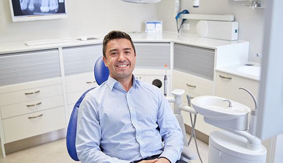 Male dental patient smiling after root canal therapy in Panama City, FL
