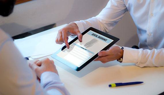 Showing patient dental insurance information on tablet