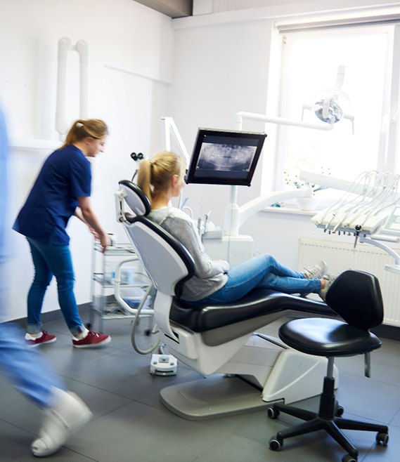 patient sitting in dental chair 