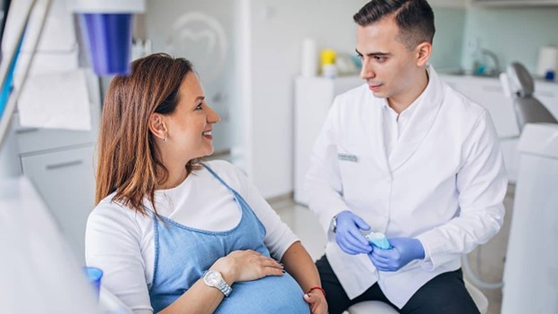 patient speaking with dentist about dental sedation while pregnant