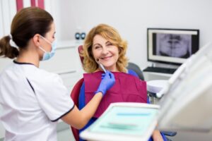 Older woman smiling after her cosmetic dental treatment